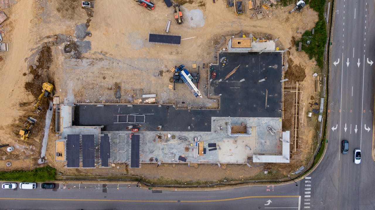 Aerial view of an active construction site with machinery and vehicles.